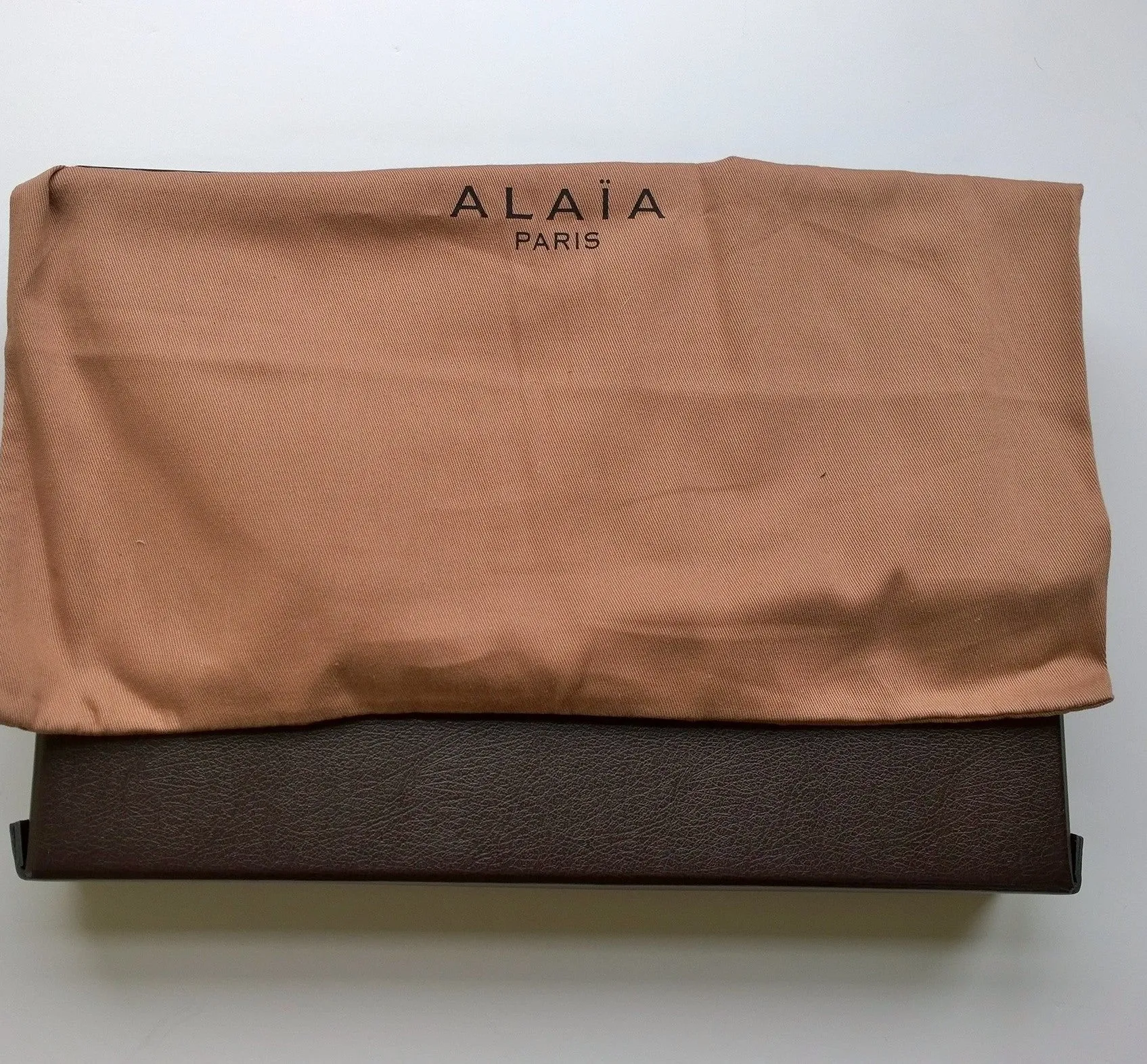 Alaia Arabesque Black Leather laser cut white backing clutch evening bag